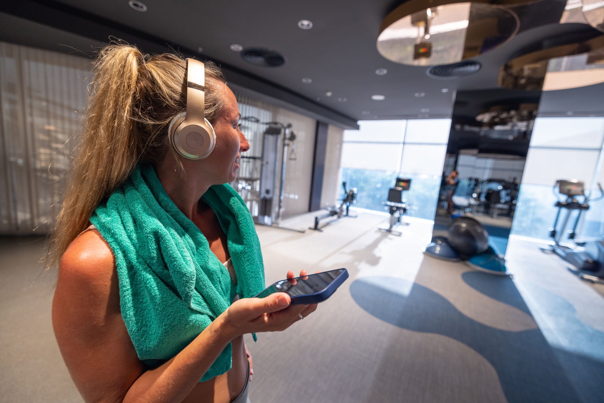 Woman Monitoring Workout Progress on Smartphone in Gym